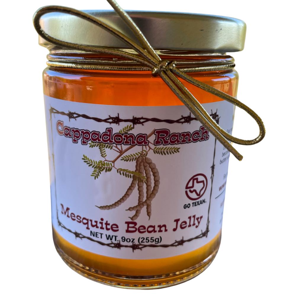 Close-up of Cappadona Ranch Sweet and Smoky Mesquite Bean Jelly jar with gold bow on white background